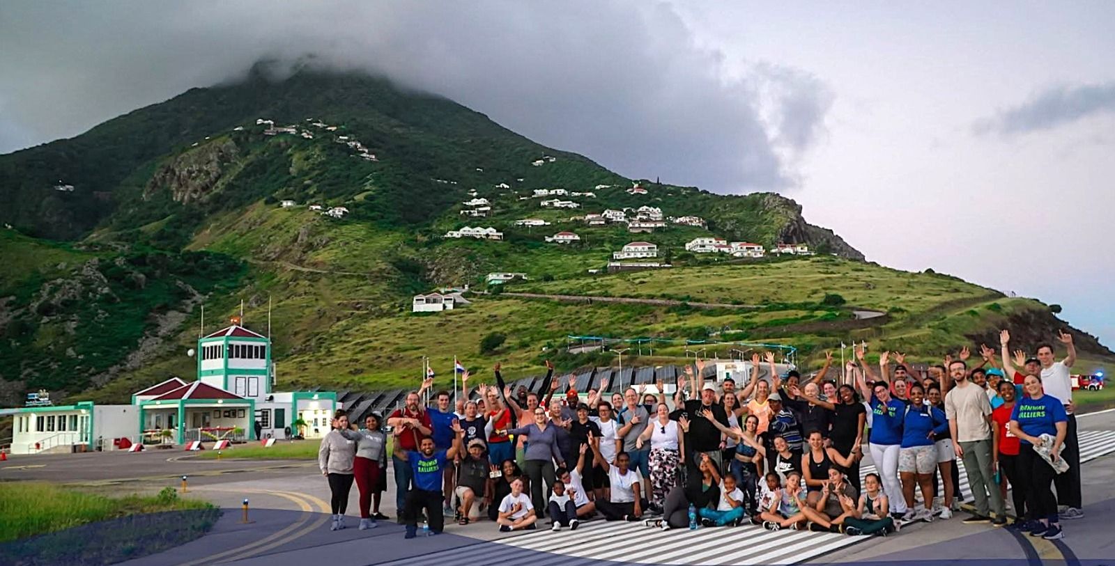 Saba residents gathered on the runway at Juancho E. Yrausquin Airport, with Zion's Hill behind