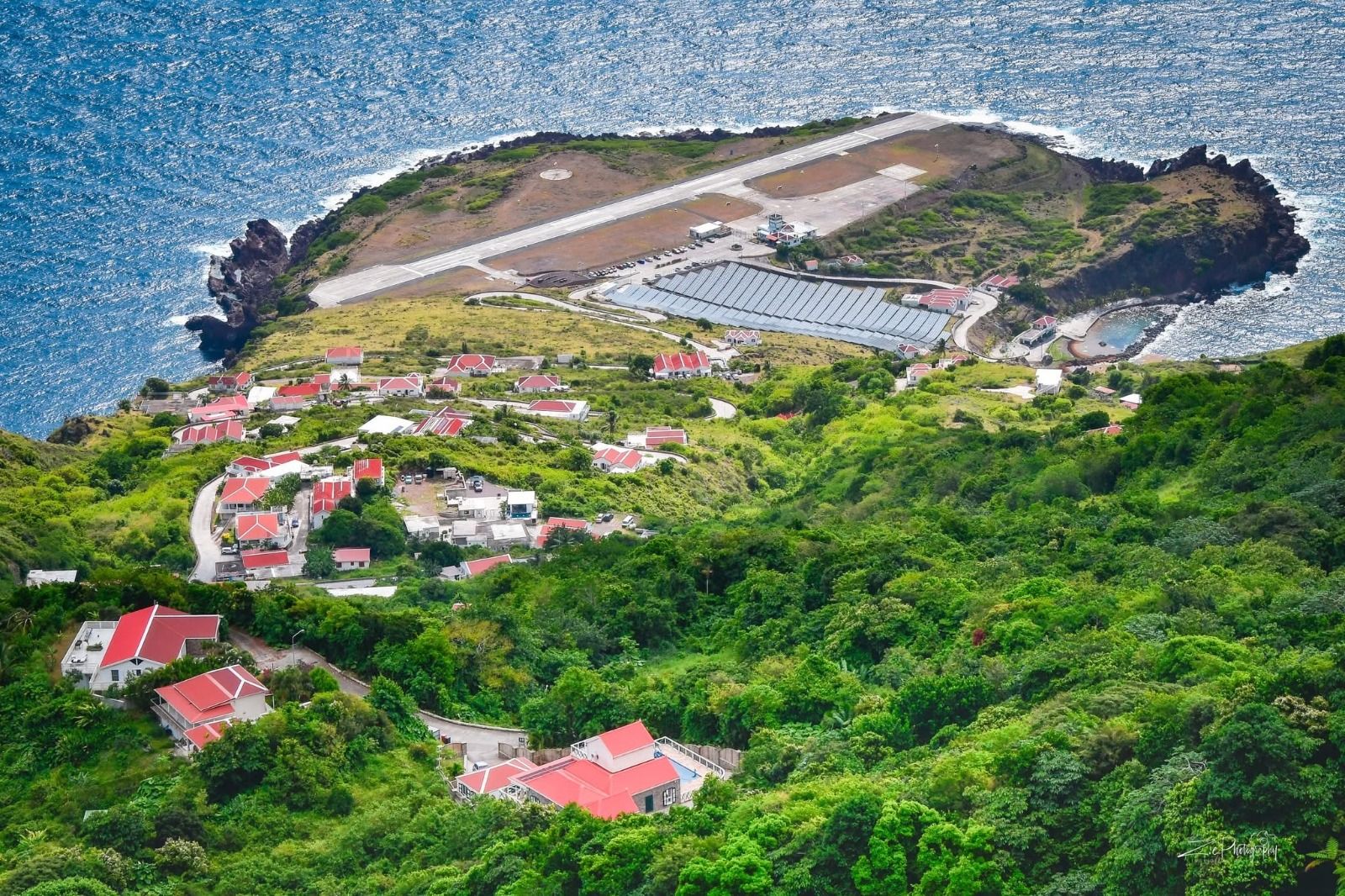 Red-roofed homes of Zion's Hill above Saba's airport and the Caribbean Sea